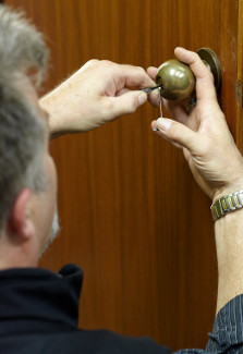 Locksmith picking an office door lock